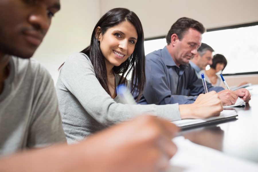 Woman looking up from lecture and smiling